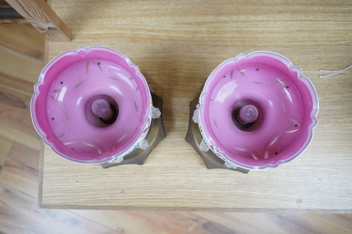 A pair of Bohemian/Czech overlaid glass table lustres raised on octagonal pierced metal bases, 31cm high